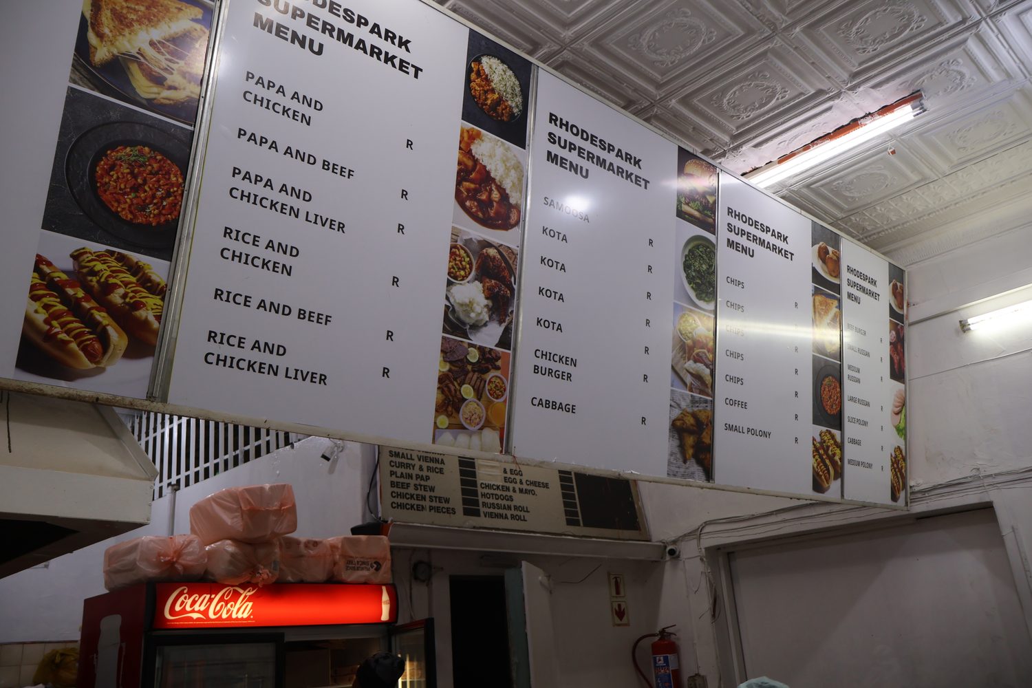 The Rhodes Park take-away menu board on the wall in store