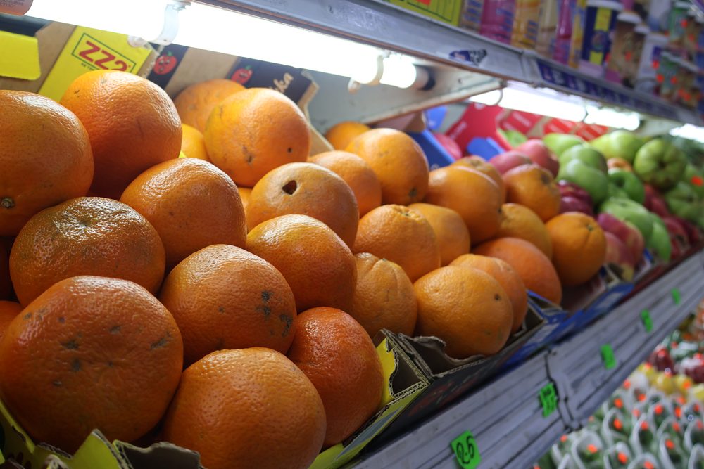 Baskets of fresh fruit and vegetables in store